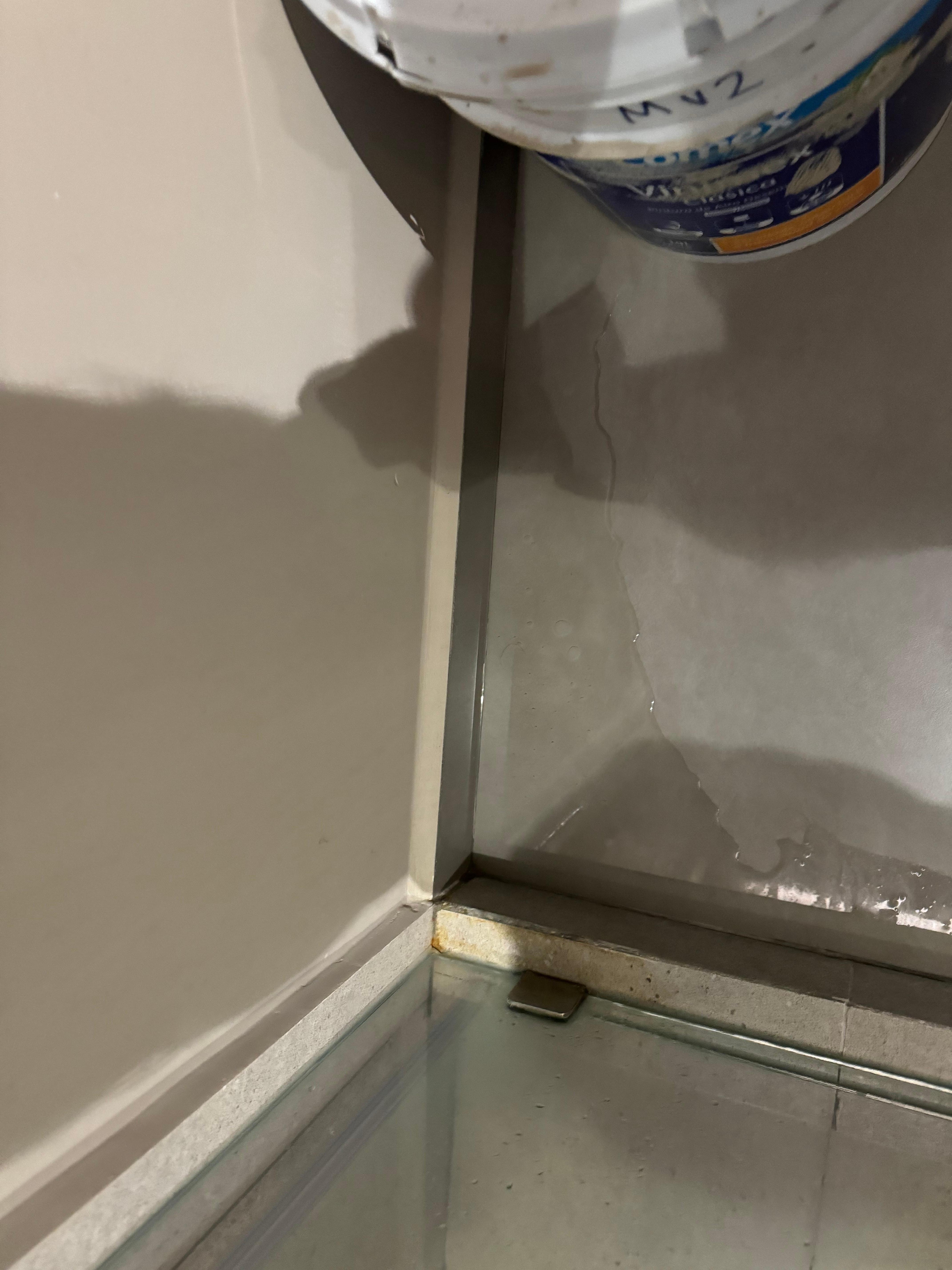 Bathroom flooded after the shower because of a leak between the wall and the shower screen
