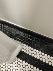 Dirty debris behind sink