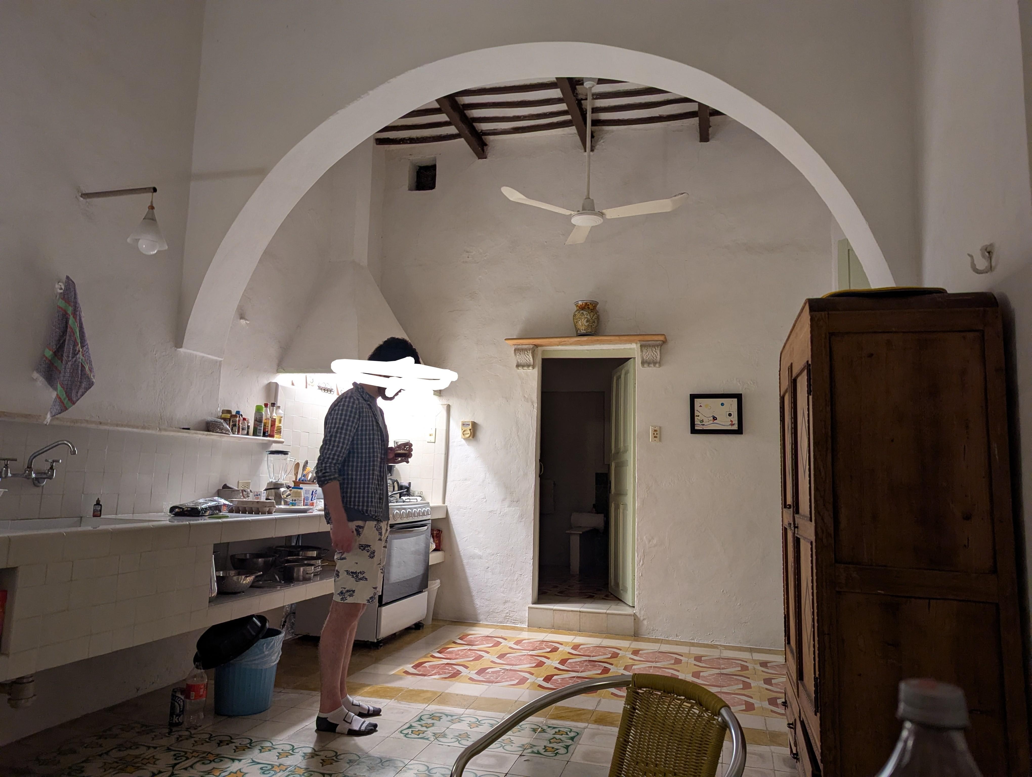The main kitchen/dining area with high, beamed ceilings and doors onto the courtyard. 