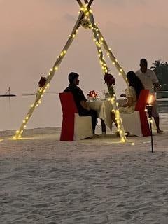 Couple having romantic dinner on Kakuni Beach