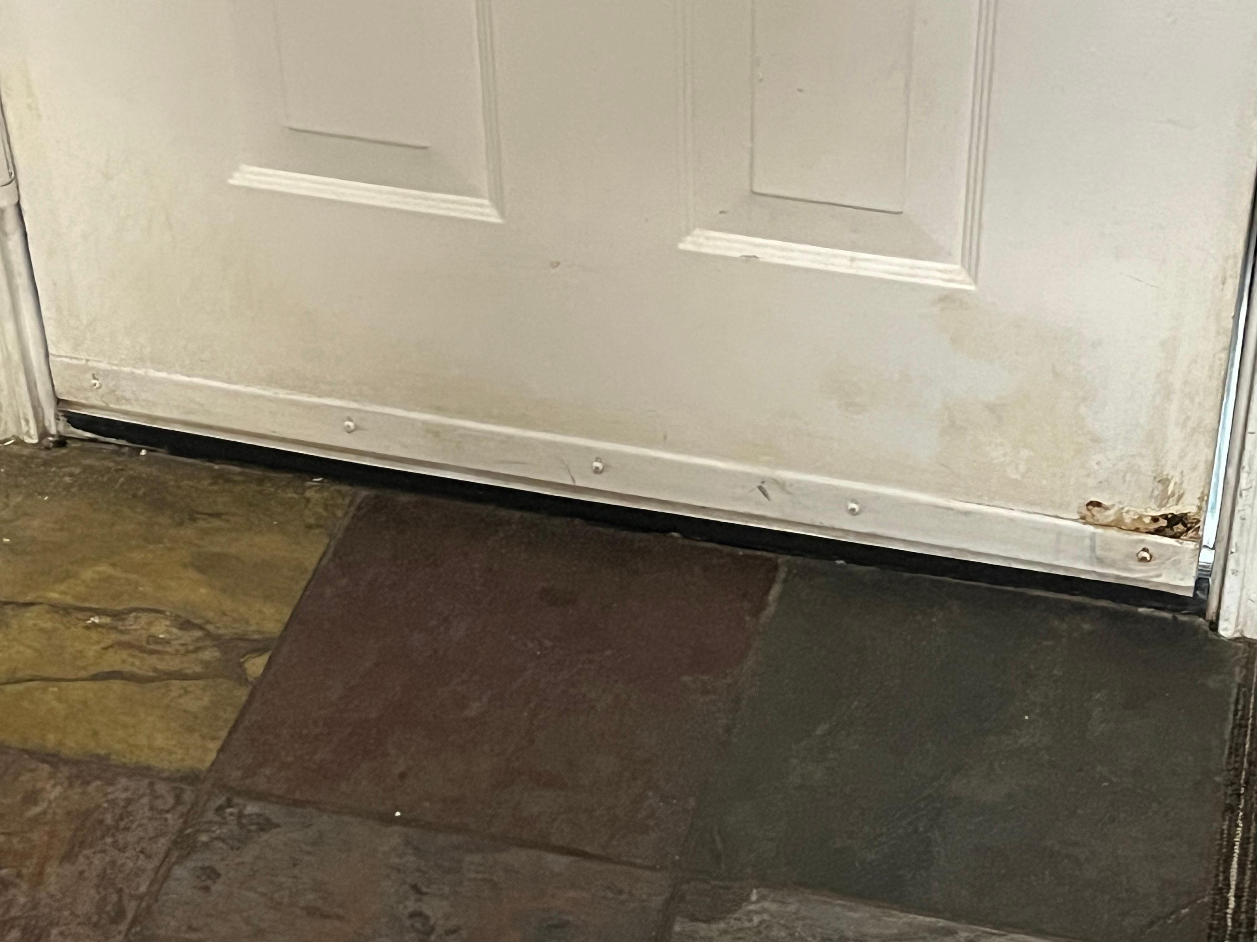 Dirty on floor and stains on the door and walls