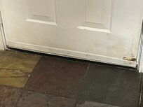 Dirty on floor and stains on the door and walls