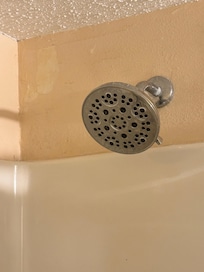 Old shower head and dust on the wall
