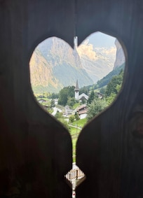 The church through  a heart shaped opening off the terrace.