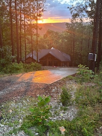 Sun setting on the mountains behind the house after it rained.