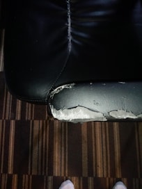 the chair which was shoved under the desk I guess gets this damage on the arms because the desk actually hangs at a downward angle and a pen placed on the desk rolls off and falls onto the floor