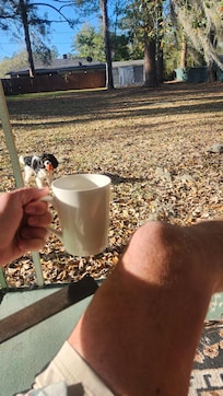 Morning coffee while playing fetch with the little beast in the backyard