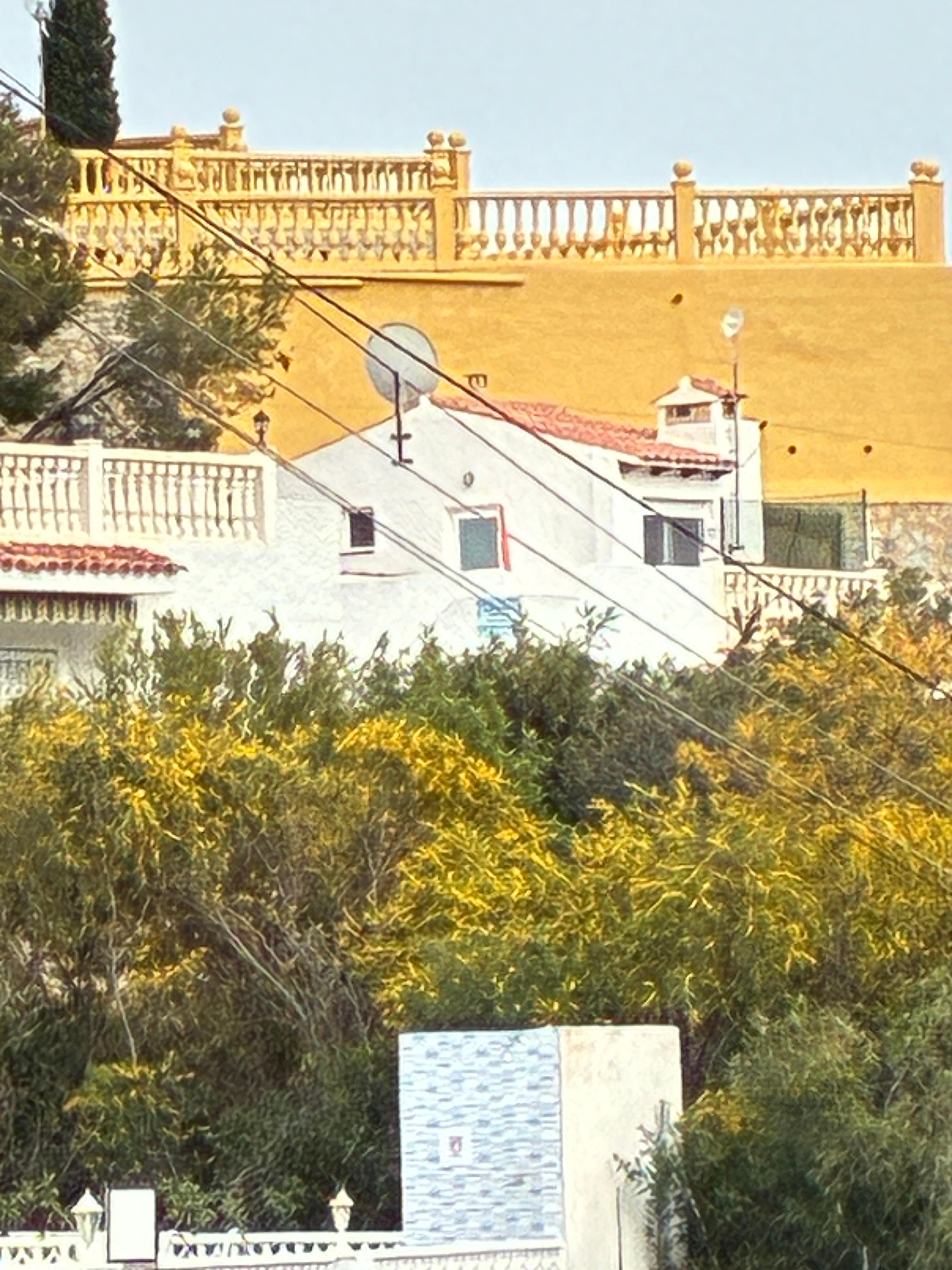 The roof terrace and apartment from the pool area 