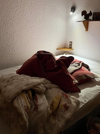 Bedding thrown on bed from previous guest