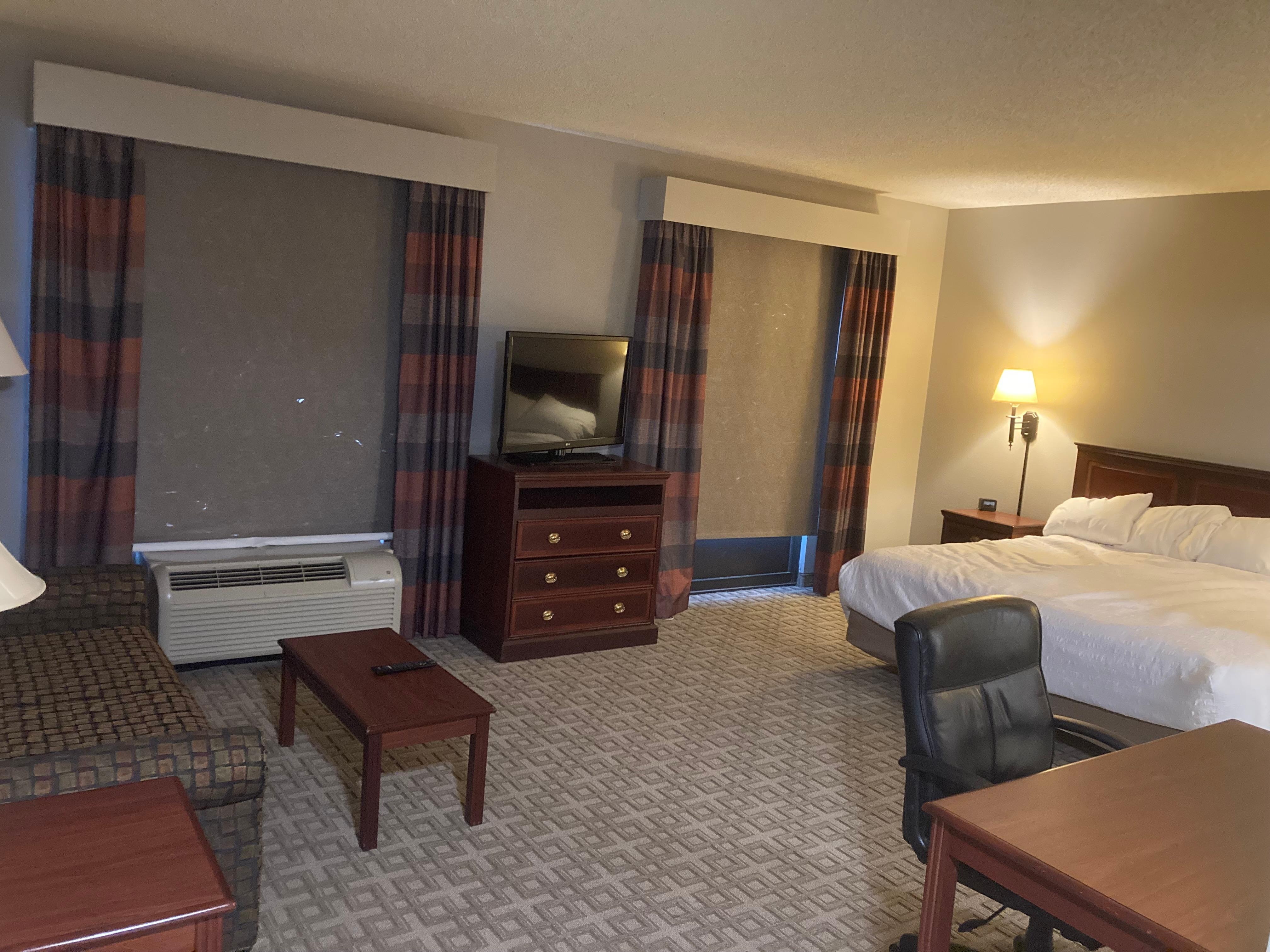 King Bed, sofa, Work Desk and Dresser with TV on it.
