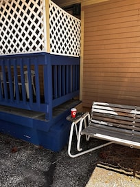 Nice swinging bench with a view of the huge pine trees to enjoy your coffee