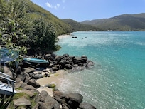 Looking east from the waterside deck at the pocket beach below our unit.