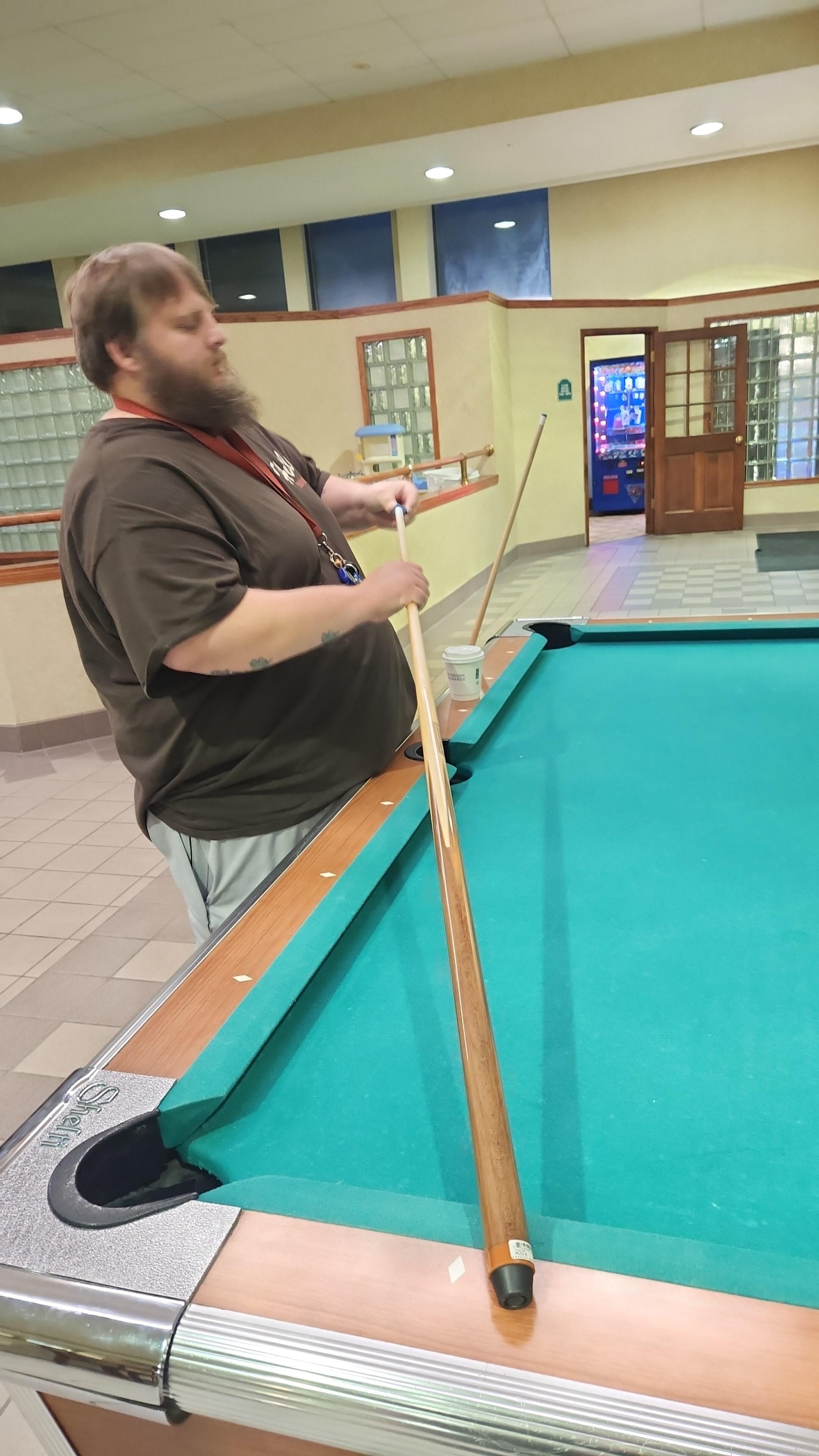 Pool table in the breakfast area, next to the pool. 
In the background you can see the entrance to the arcade games area 