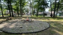 A beautiful corner lot with a large fire pit.