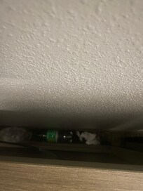 Trash piled up behind furniture