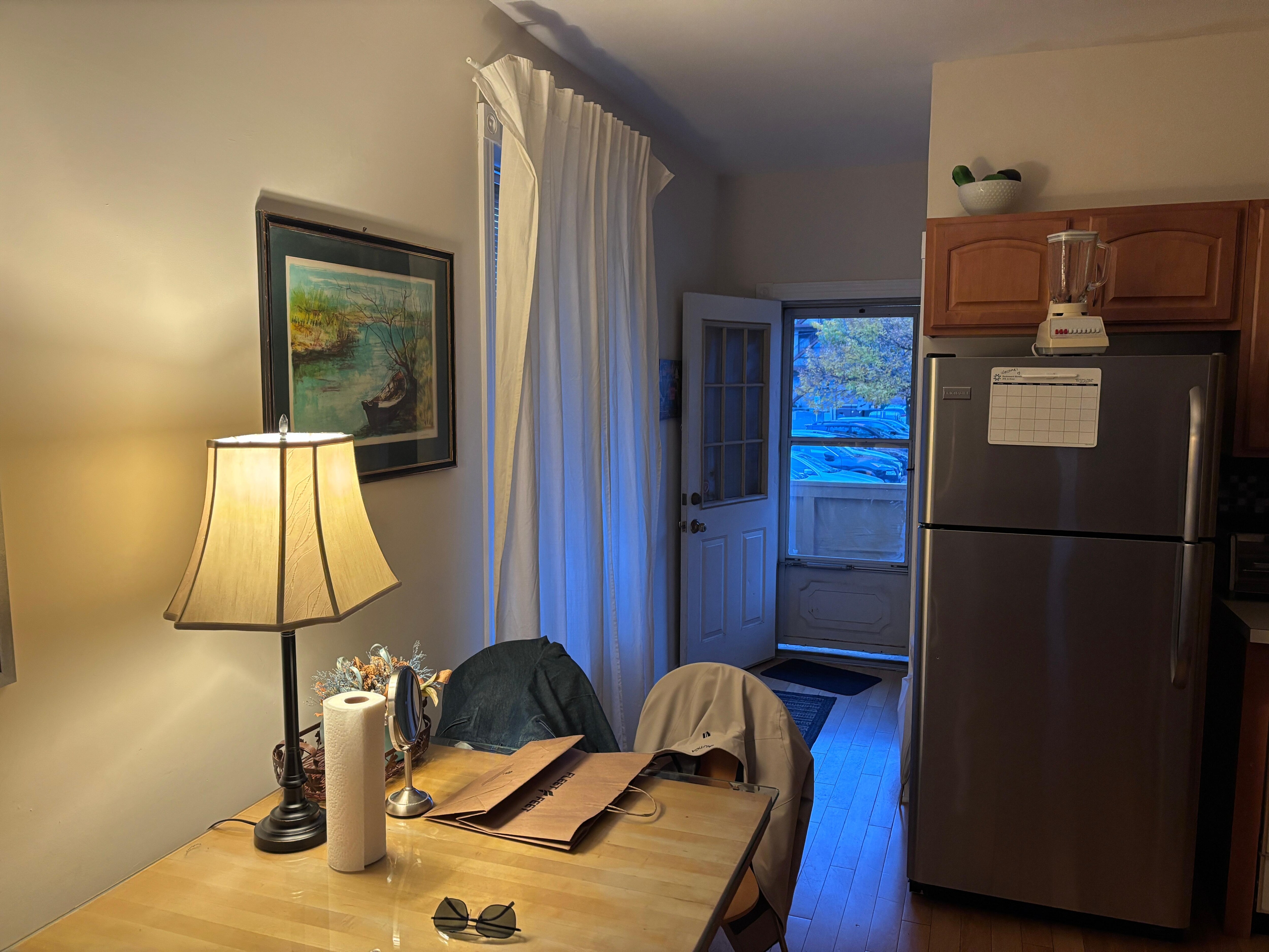 View through dining area and kitchen to back door