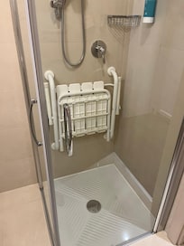 Small shower with both glass panels opening for wheelchair access