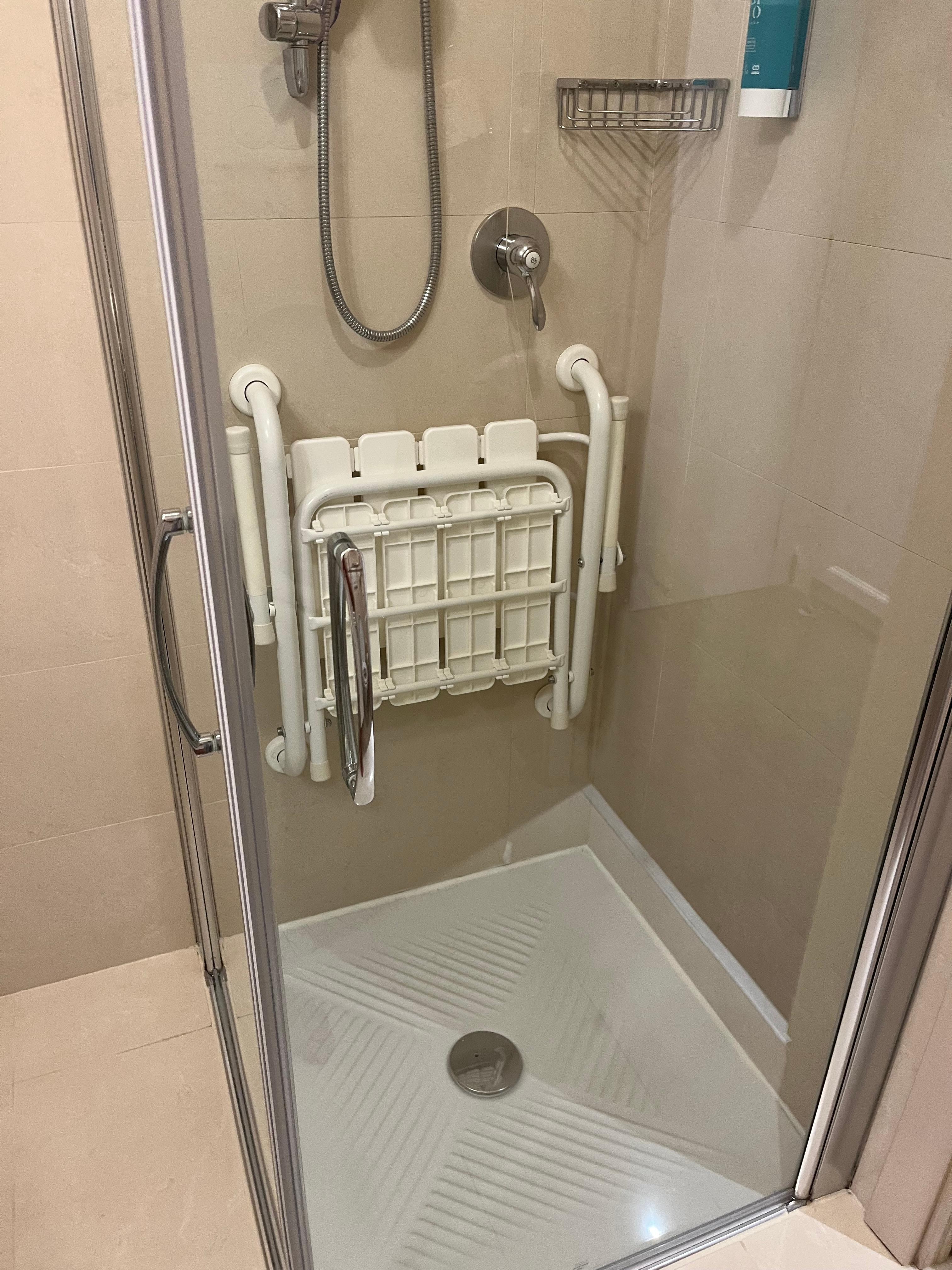 Small shower with both glass panels opening for wheelchair access