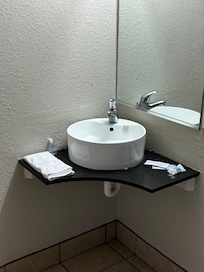The only counter space in the entire bathroom. A spider was in my face towel.