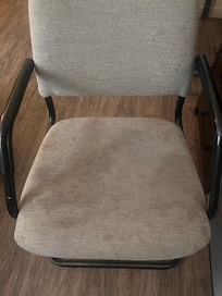 One of the chairs in the room to sit on