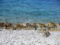 smooth rock beach and turquoise water at Kardamyli