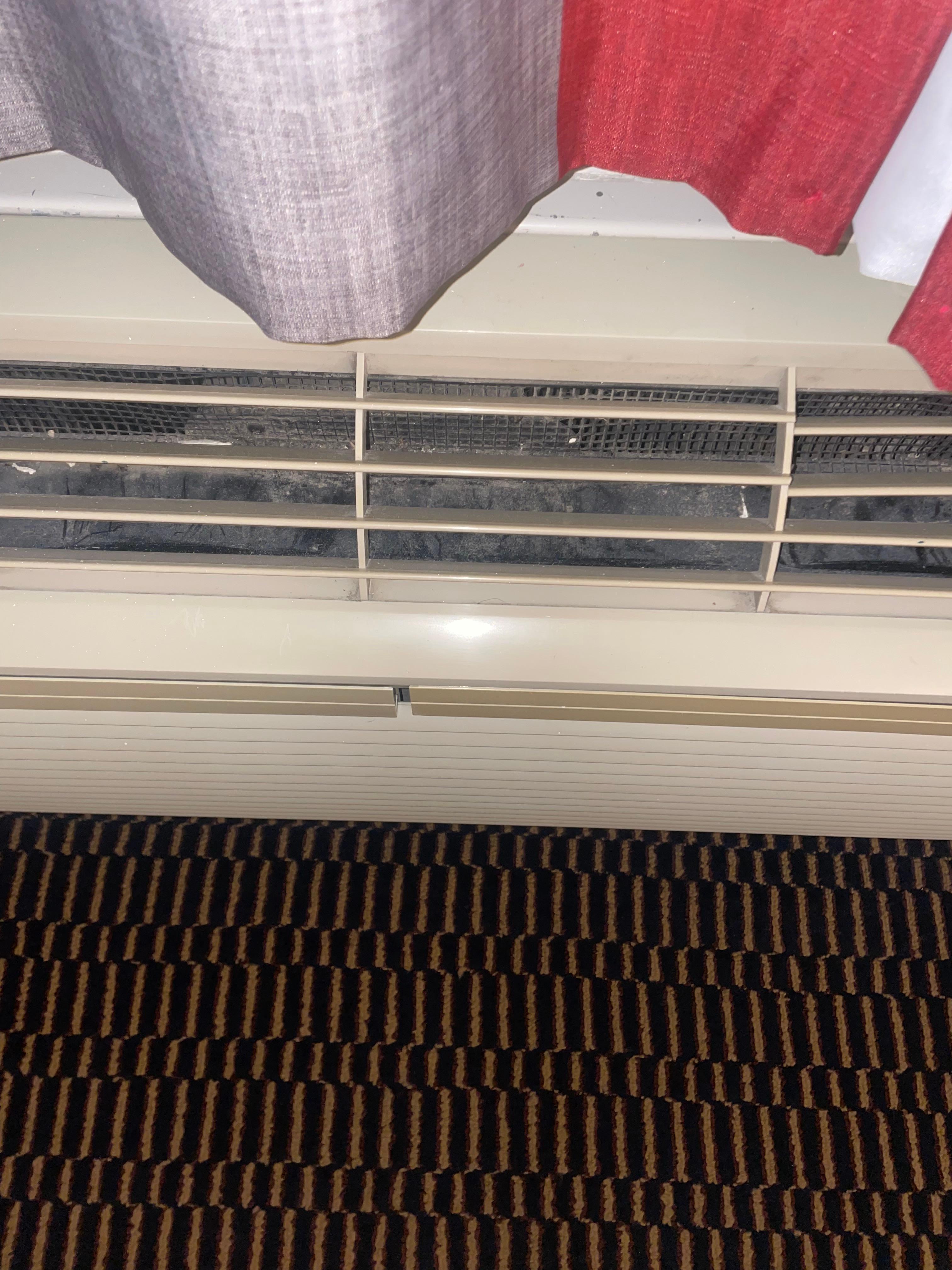 Very dirty and moldy air conditioner in room