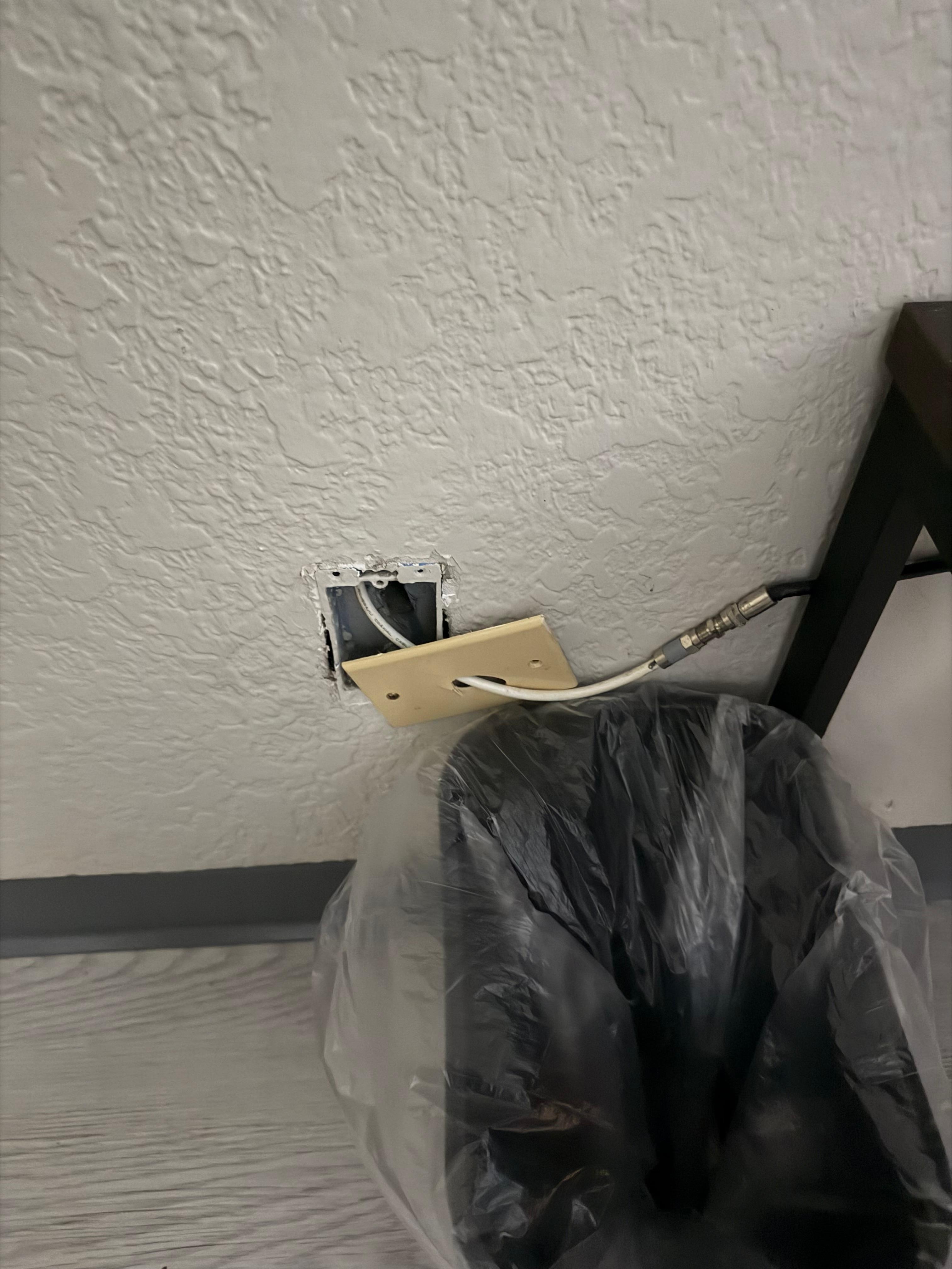 Wall outlet uncovered for cable 