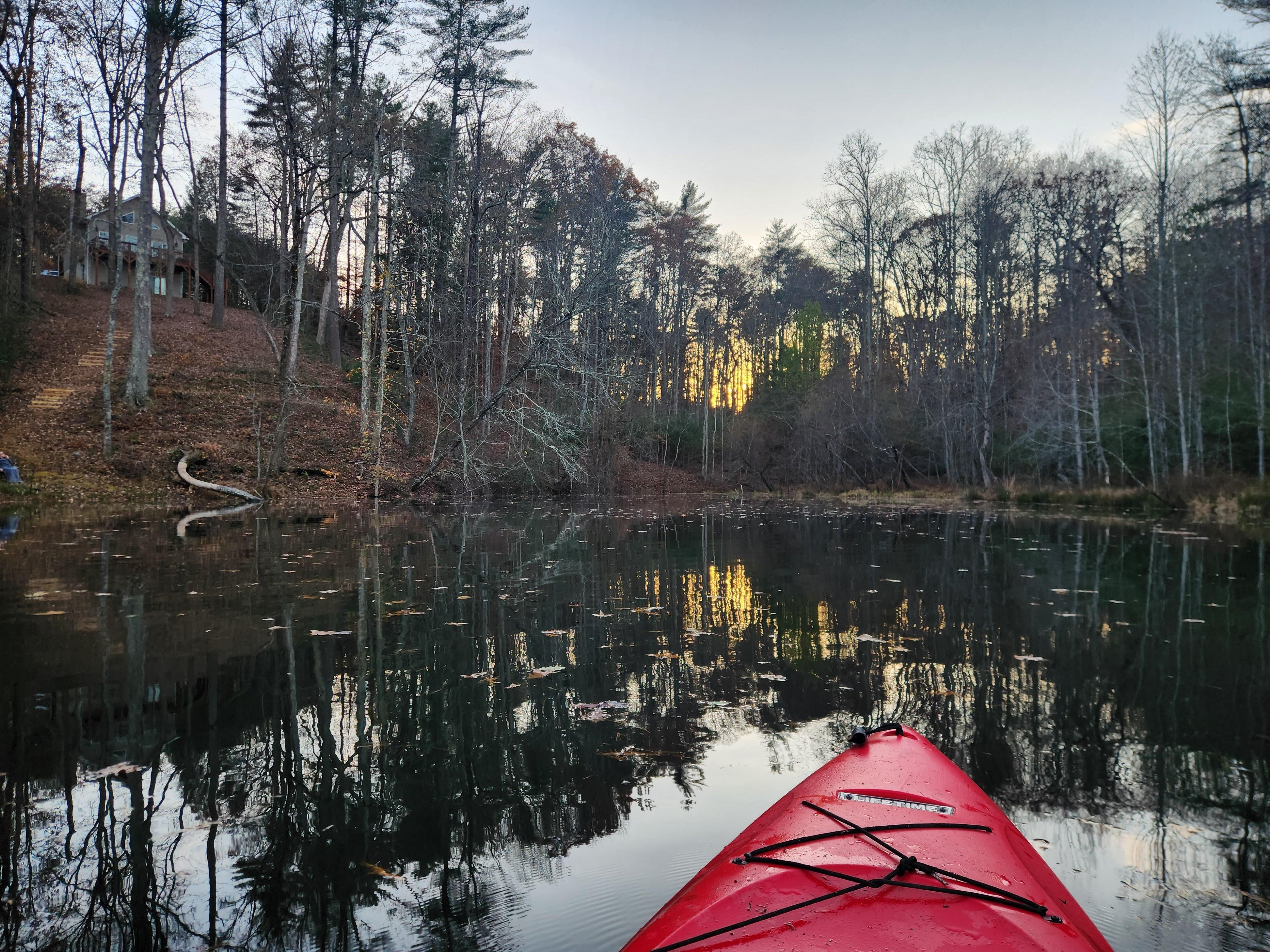 The included kayak on our little pond was fun and serene. The cabin/house is just up the hill in this photo. 