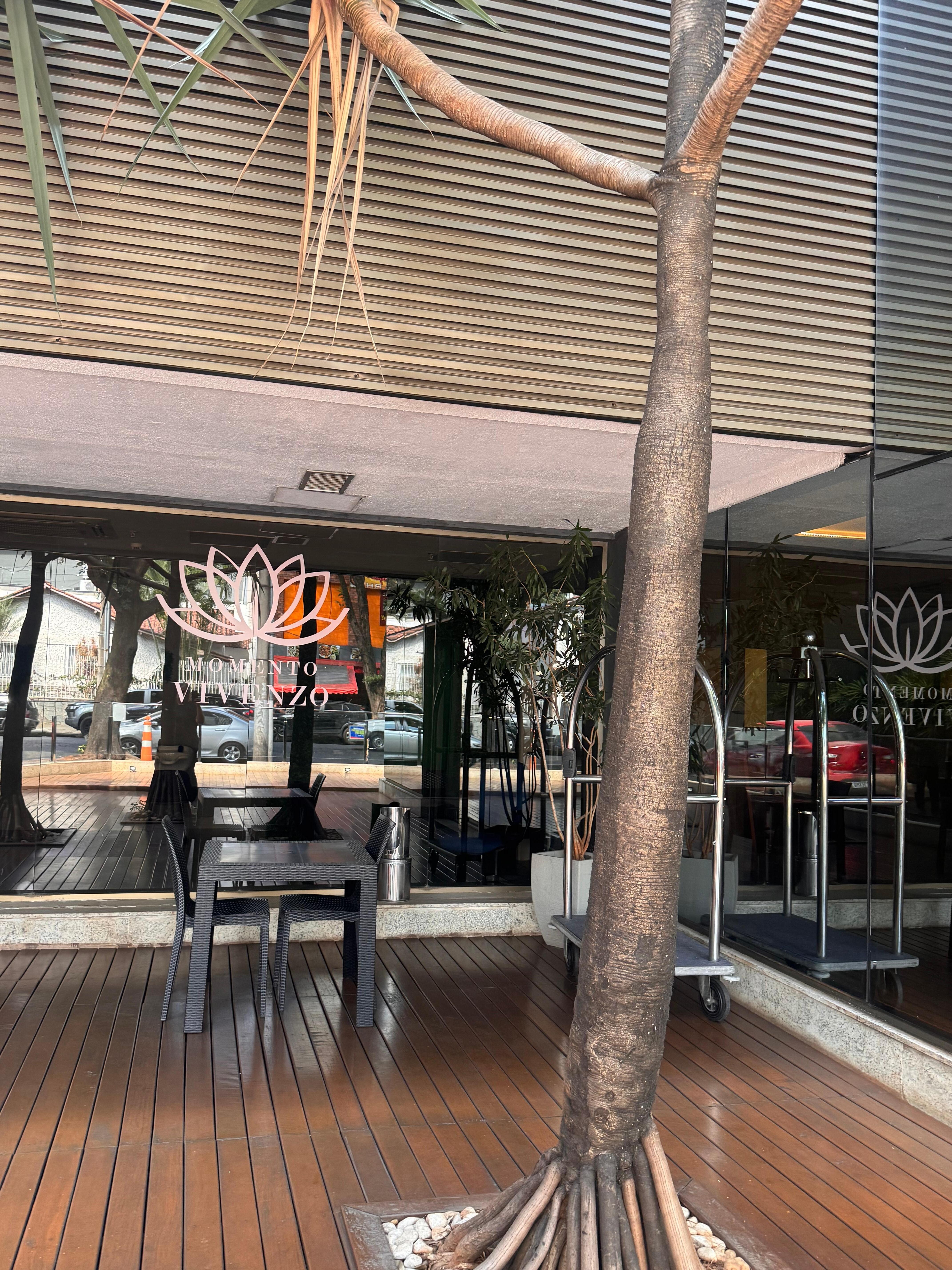 outside tables on the side of hotel 