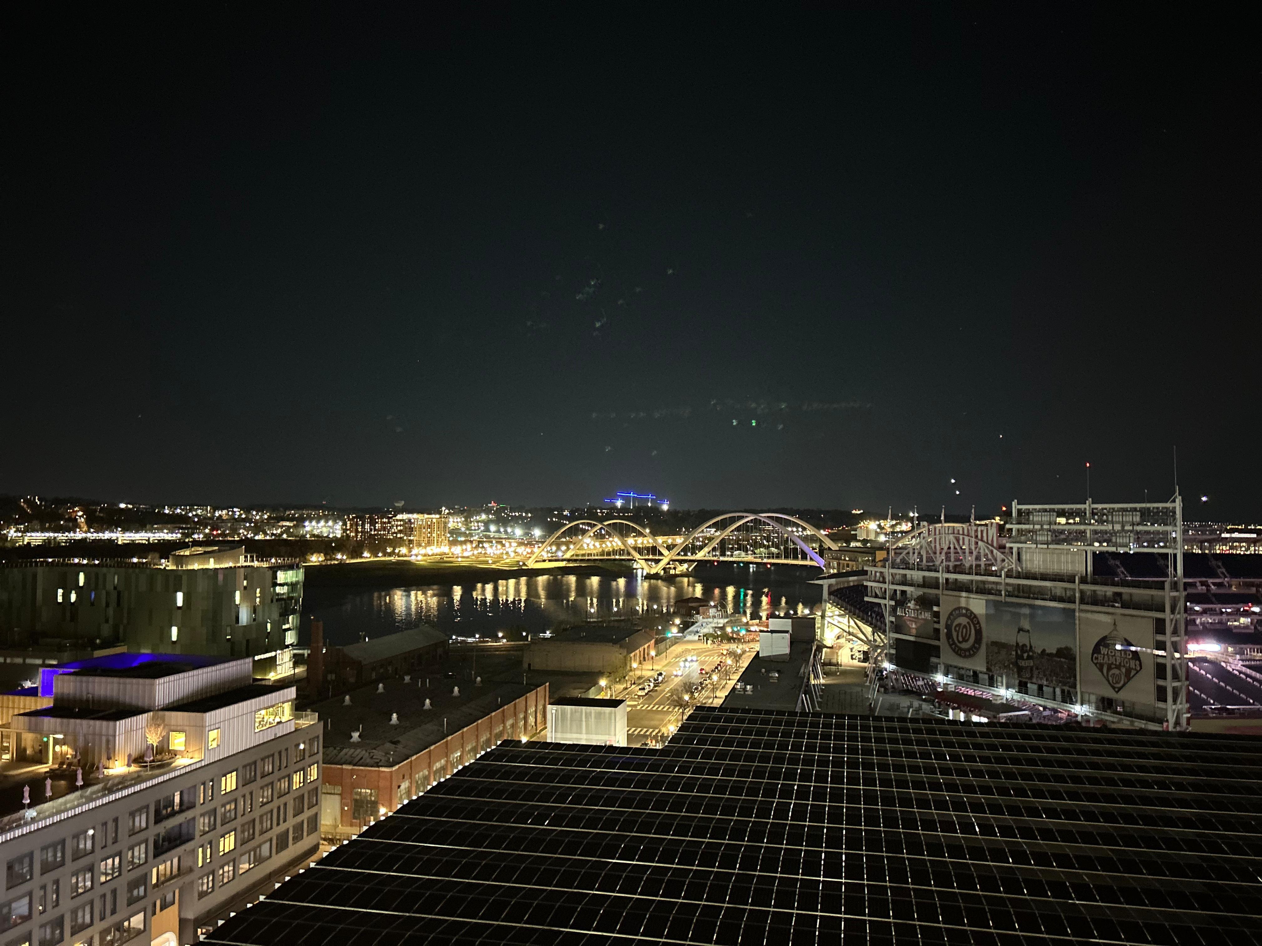 Night view with a drink in the rooftop 