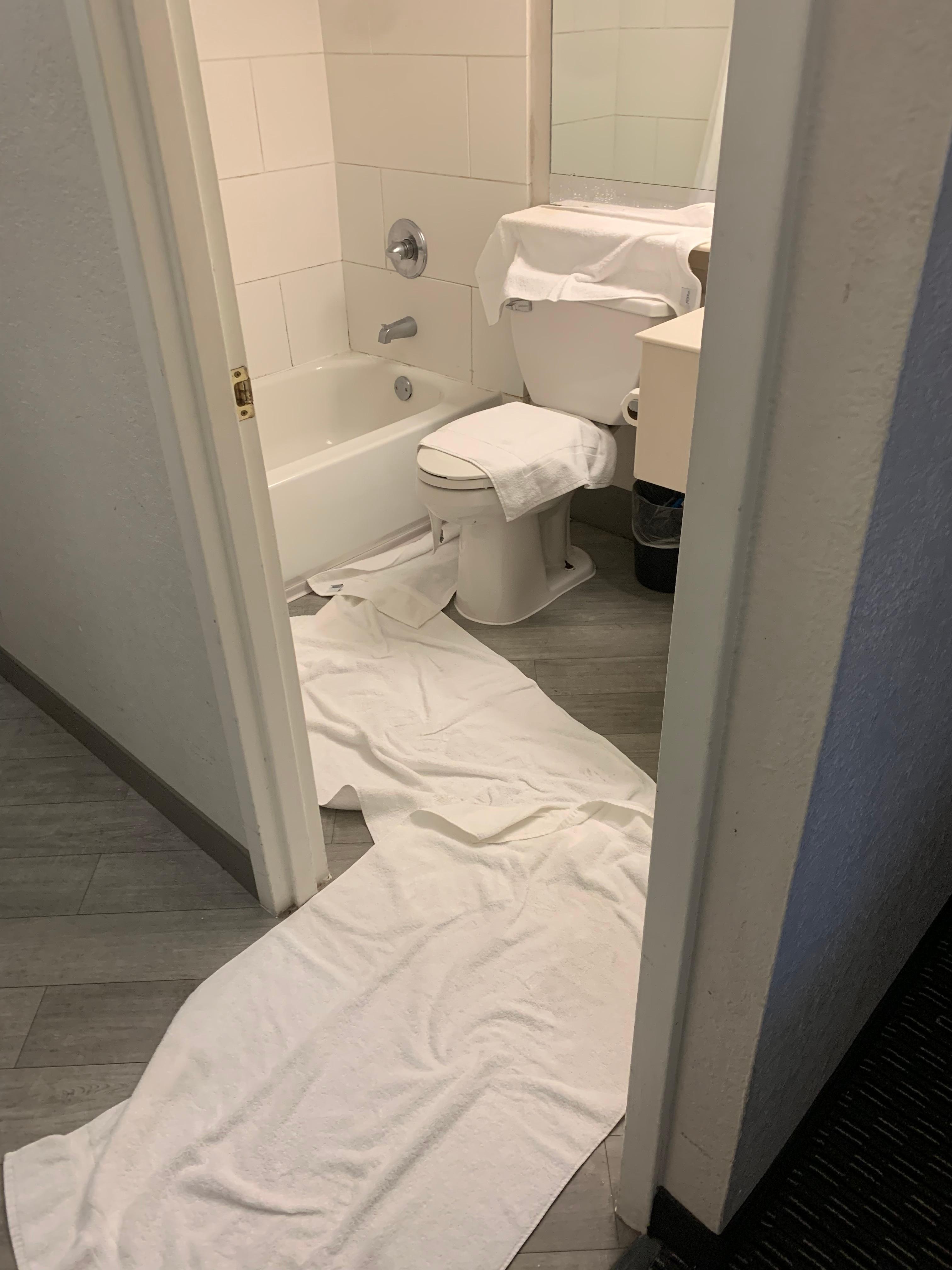 Water running from ceiling and vents onto counter, toilet and floor.