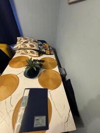 There is a table shoved in a room that has the fold out sofa bed that cannot be used once using the bed