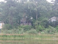 Cottage from row boat in pond