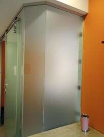 The opaque shower wall doubles as a wall by the desk.