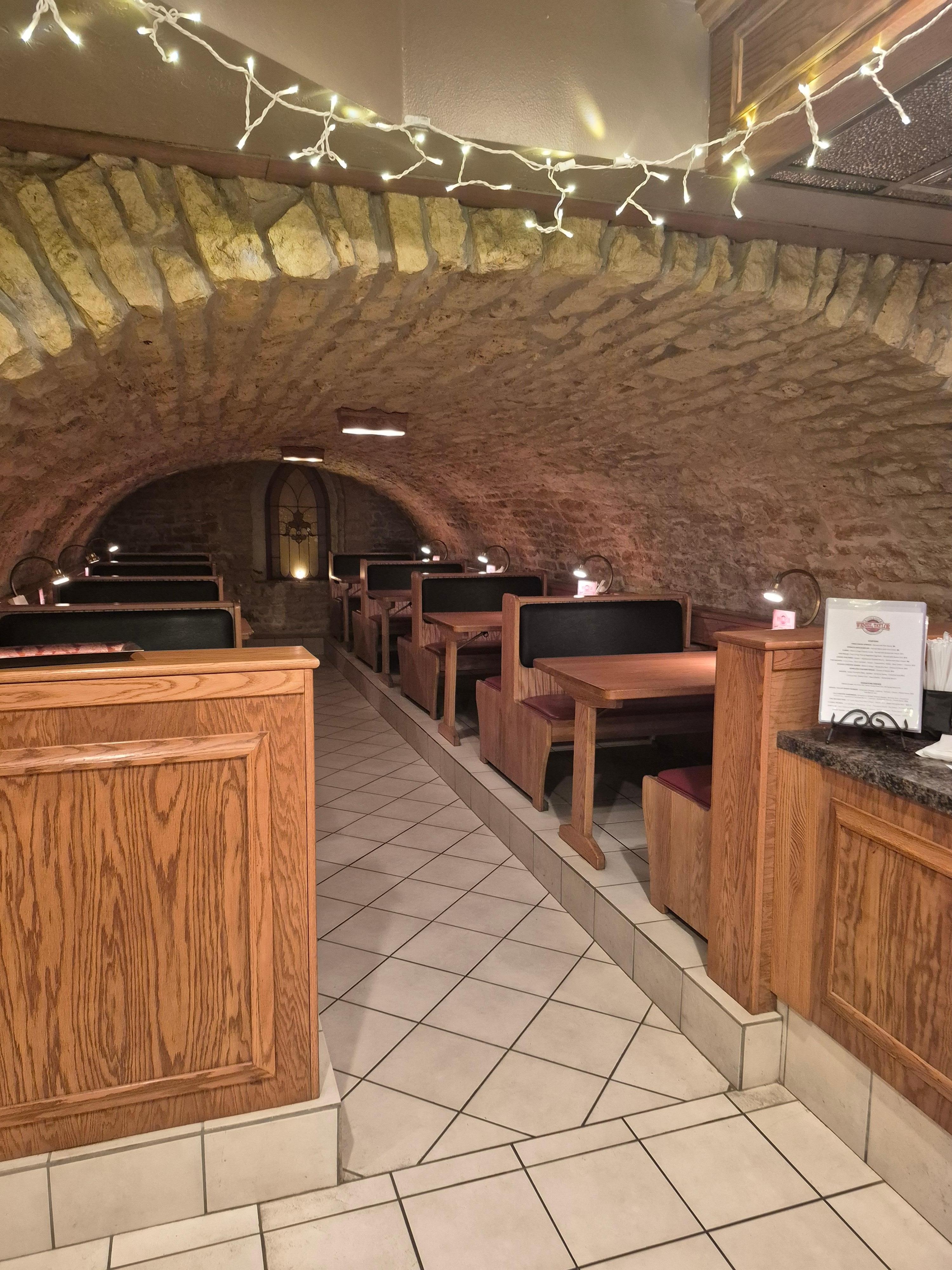 Eating area of the basement near the bar. Beautiful stone that gave a cozy private ambiance to our dining experience. 