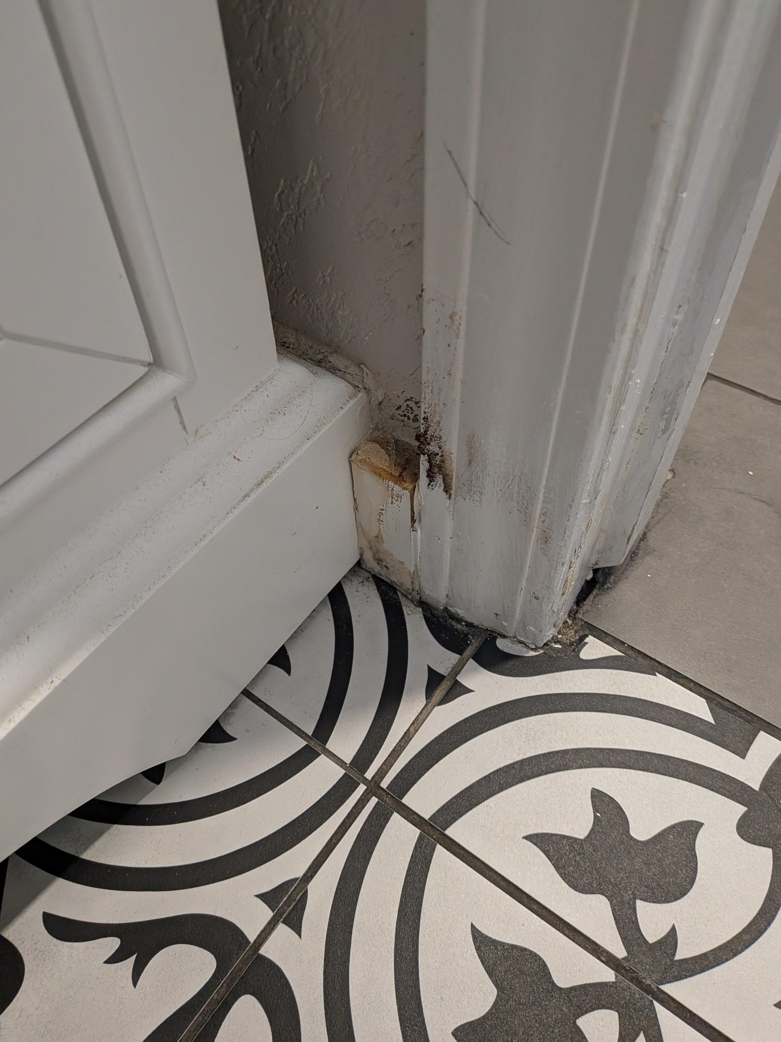 Dirty baseboard in powder room
