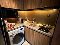 Two electric hobs, and a water heater (that's not a coffee-maker in the corner). The washing machine is very useful but the turn knob is extremely worn out, making it hard to set to the function u want.