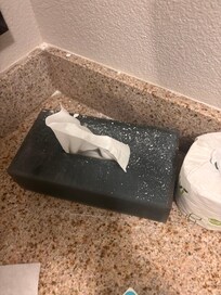 White debris in bathroom counter.