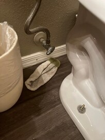 Loose toilet and dirty rag left by cleaners.