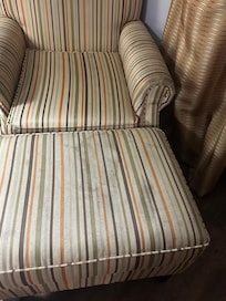 Dirty nasty chair had a roach crawling on ottoman