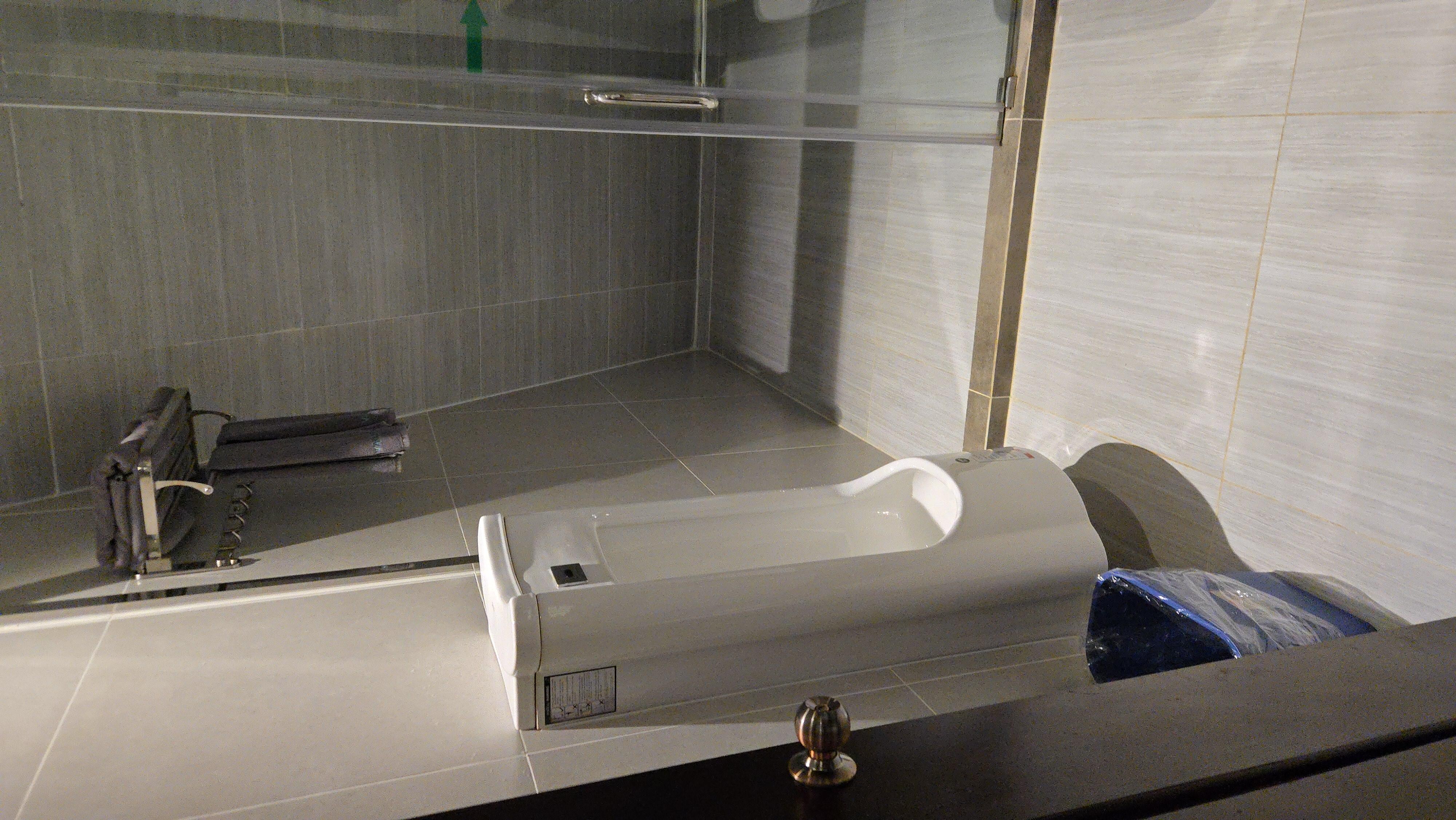 Bathroom in the bungalow. Yes that's a Urinal. 