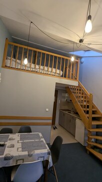 The living area and kitchen in the background