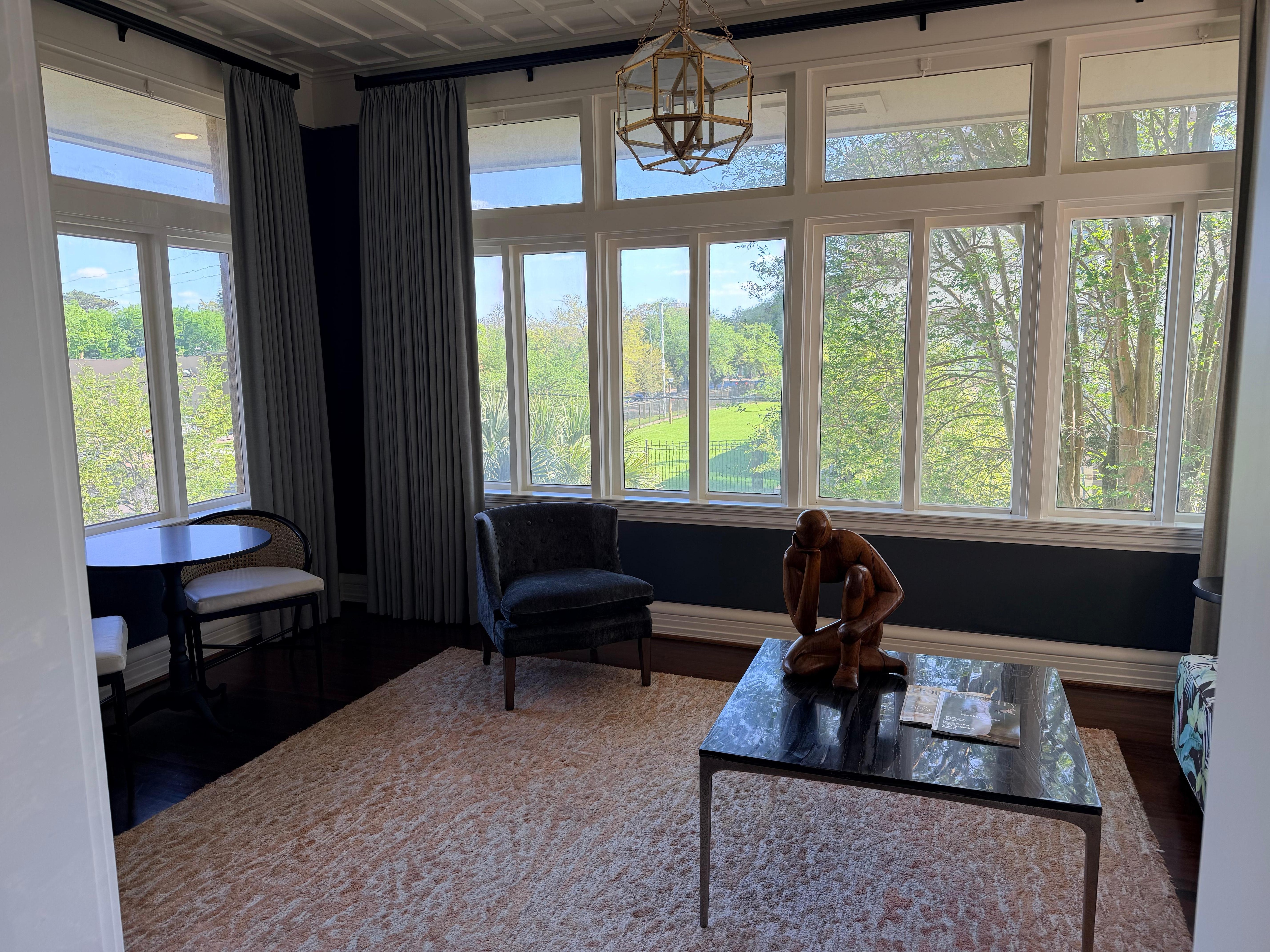 Sitting are with view of garden and city with dining table 