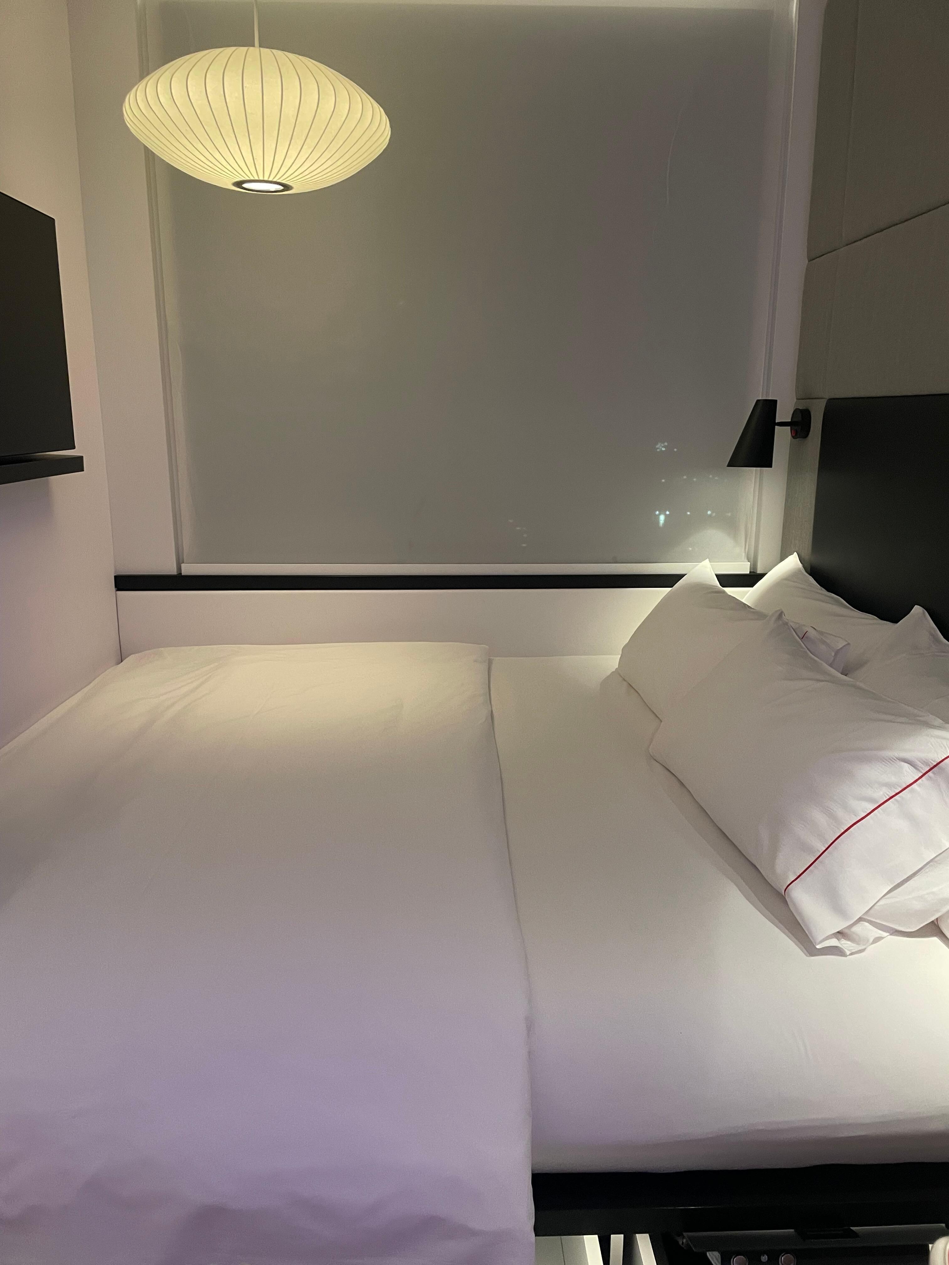 huge king size bed and light blocking curtains. Tv against the wall