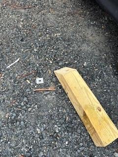 Large pieces of wood left all over the parking area, you can even see a 3 inch screw right on the floor where it used to be the parking lot.