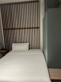 Bad is close to the shower door - no access to the other side of the bed