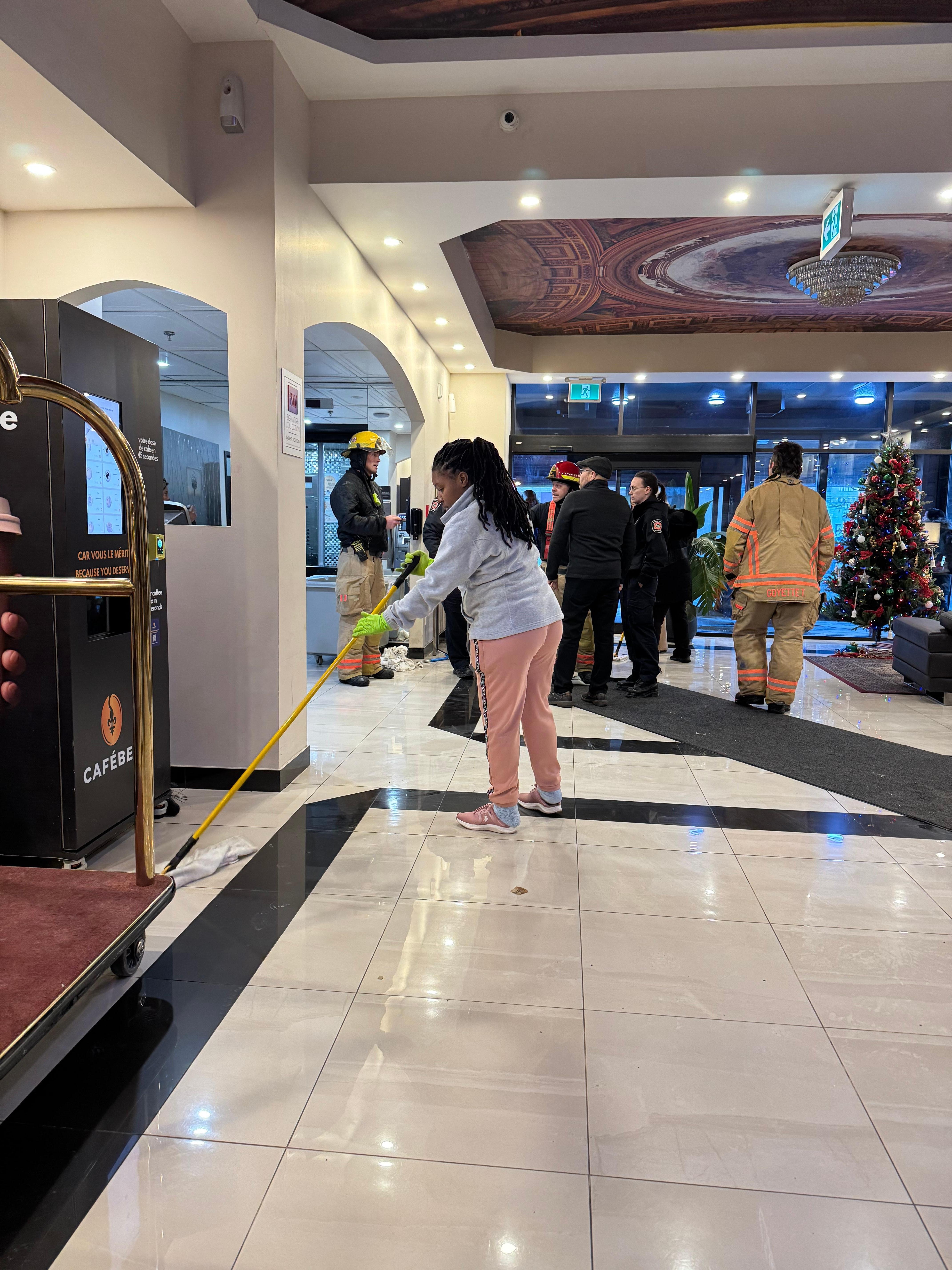 Staff was using mop to remove water from lobby 