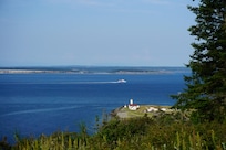 View of the Lighthouse at Ft Worden from trail