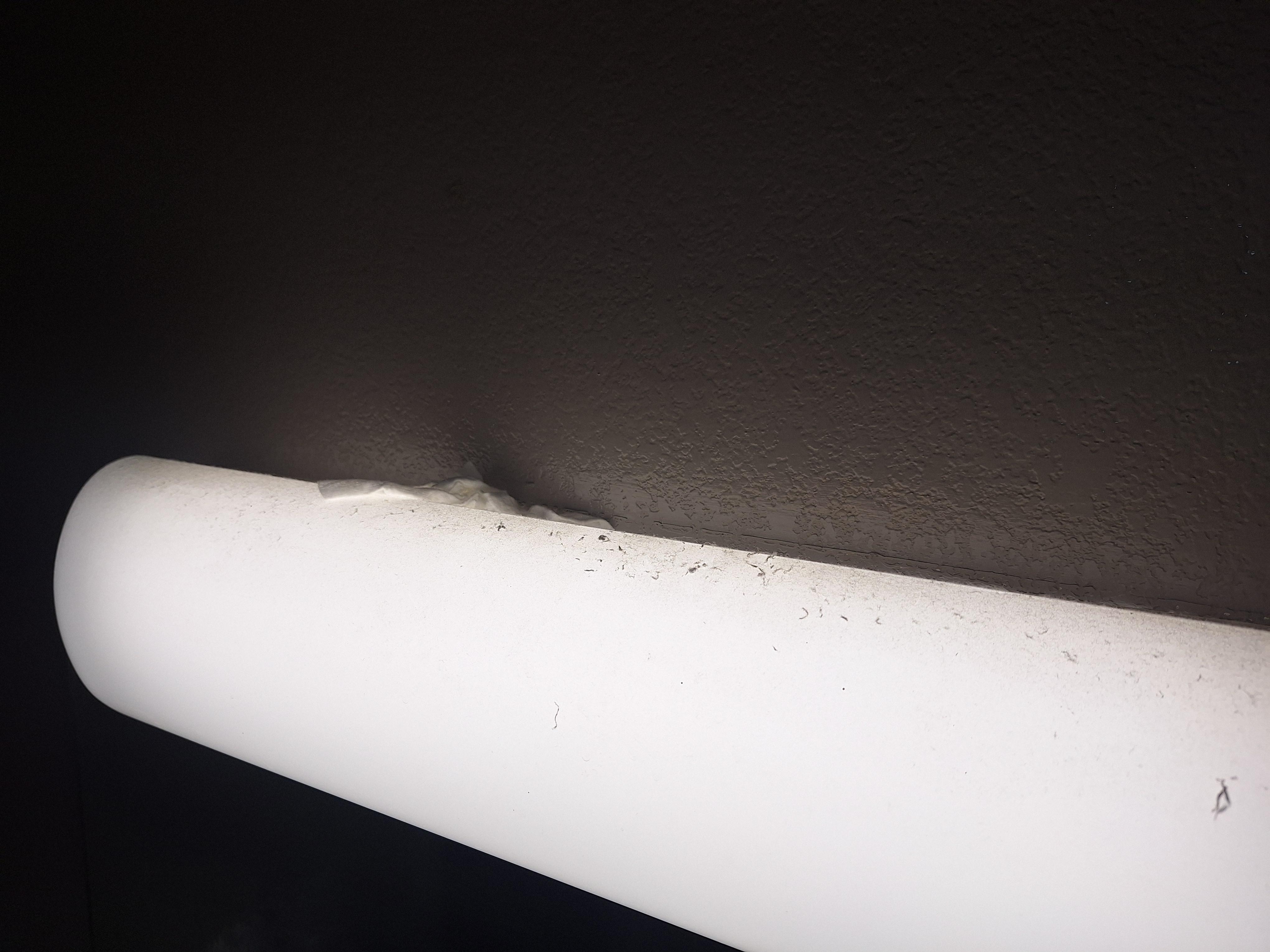 Dirty bathroom light with dirty wipe/tissue