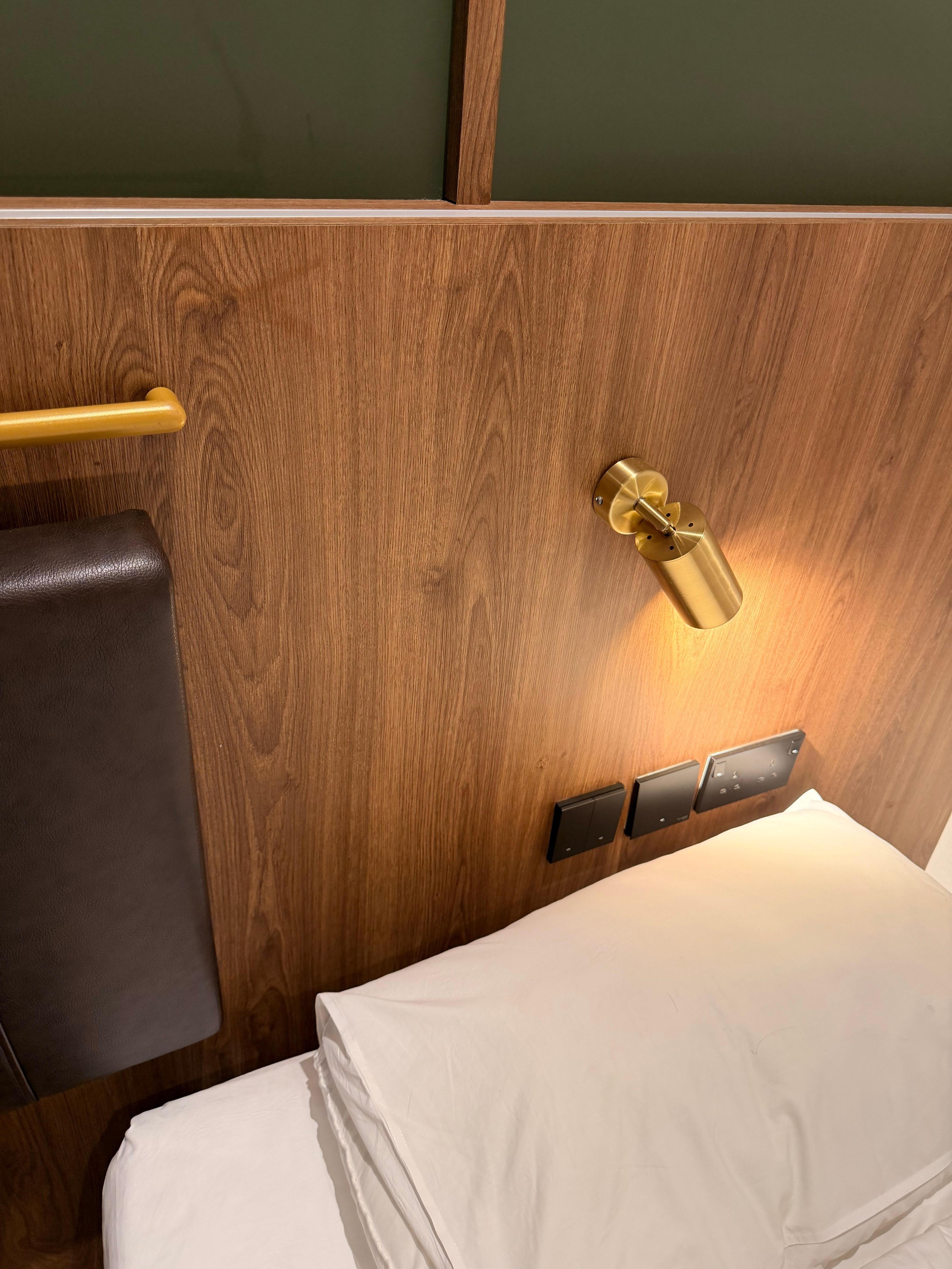 The light switches are located directly behind the pillow, and the reading light keeps touching my head.